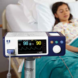A photo of a bedside patient monitor in use at a medical surgical